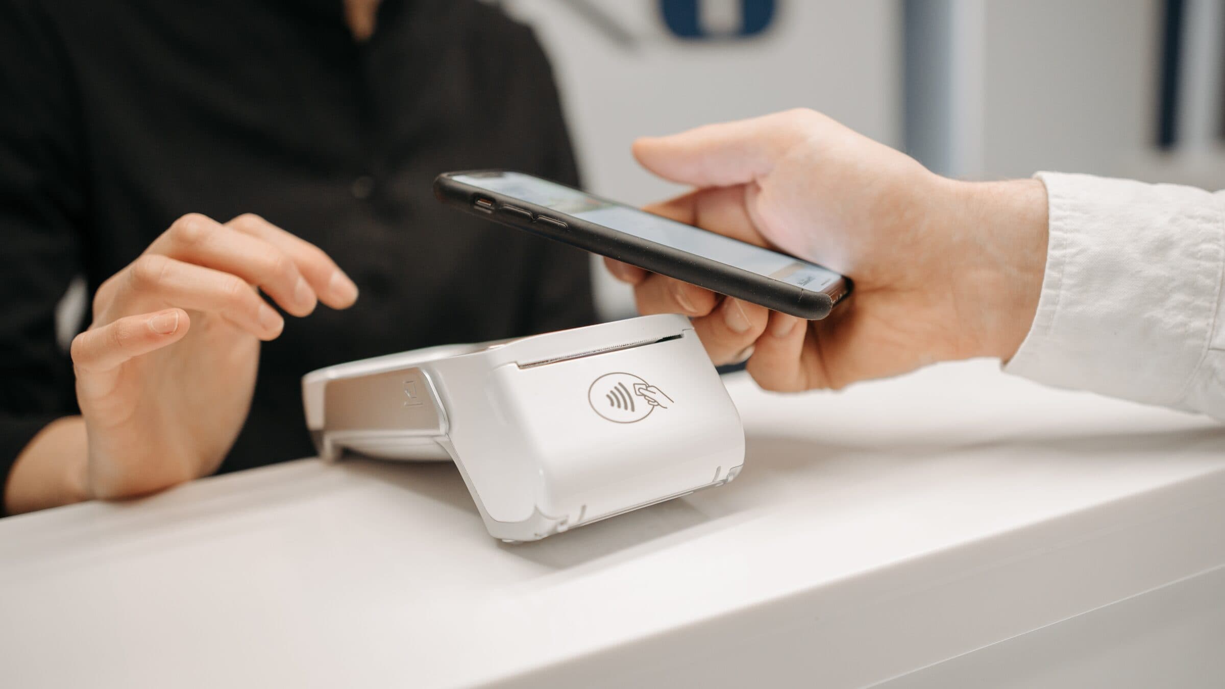 Customer paying by phone on a payment terminal